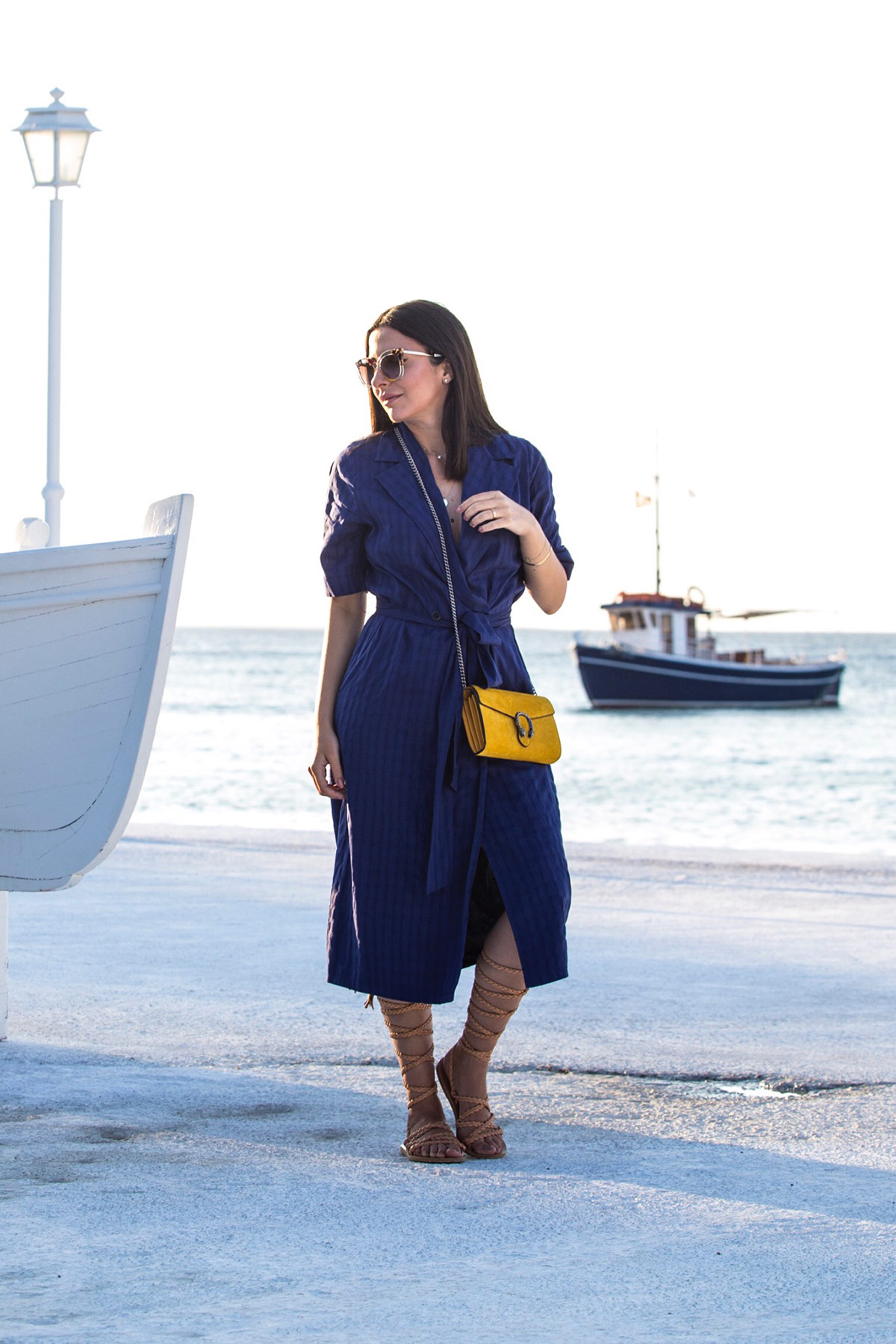 Stella Asteria wearing blue dress & yellow Gucci Dionysus bag, and Fendi sunglasses in Mykonos