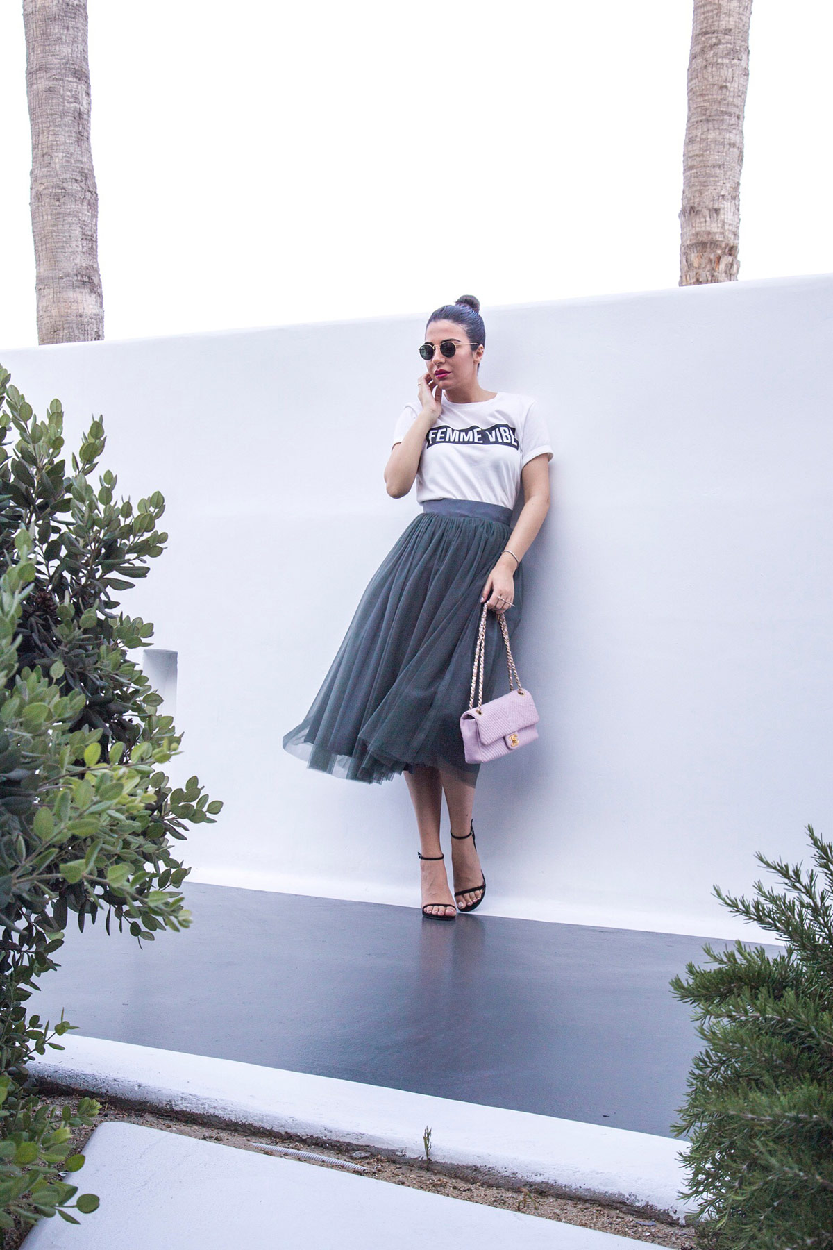Stella Asteria wearing tulle skirt with logo top, Stuart Weitzman sandals & pink Chanel bag