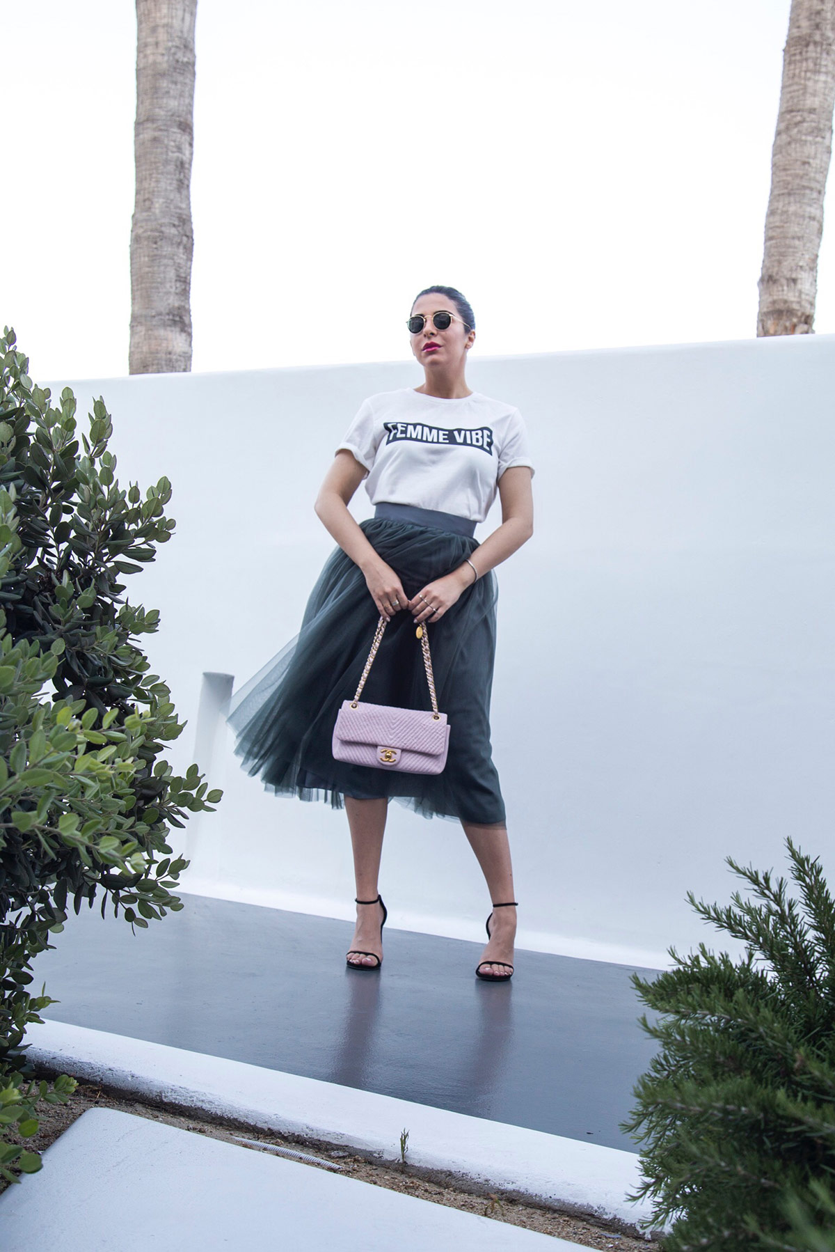 Stella Asteria wearing tulle skirt with logo top, Stuart Weitzman sandals & pink Chanel bag 