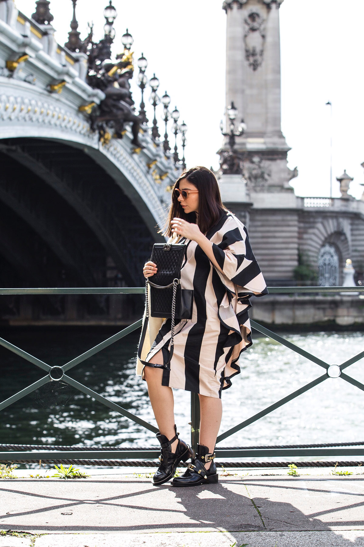 Stella Asteria wearing stripes and ruffles during Paris Fashion Week, with Chanel boy bag and Balenciaga combat boots - Paris Street Style Inspiration