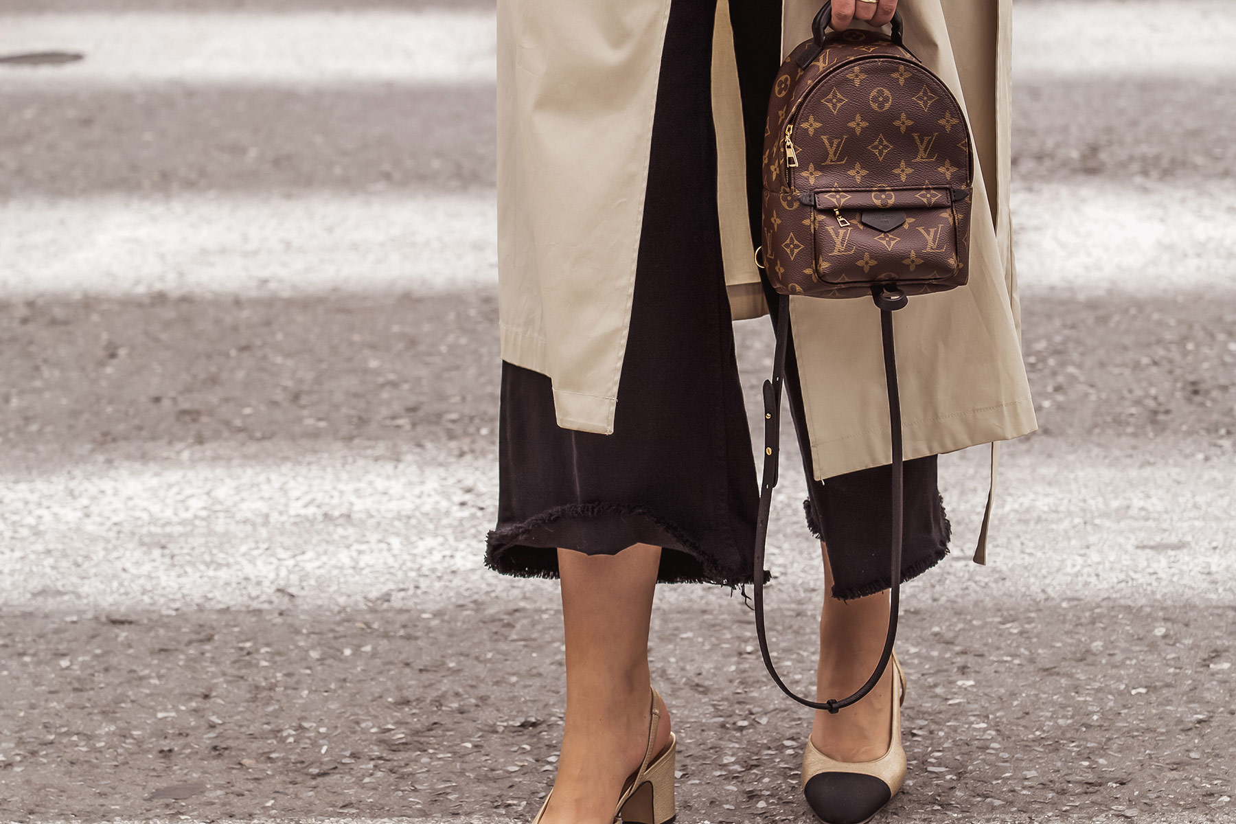 Louis Vuitton Palm Springs backpack, denim culottes, beige trench coat and Chanel classic slingbacks as seen at Stella Asteria