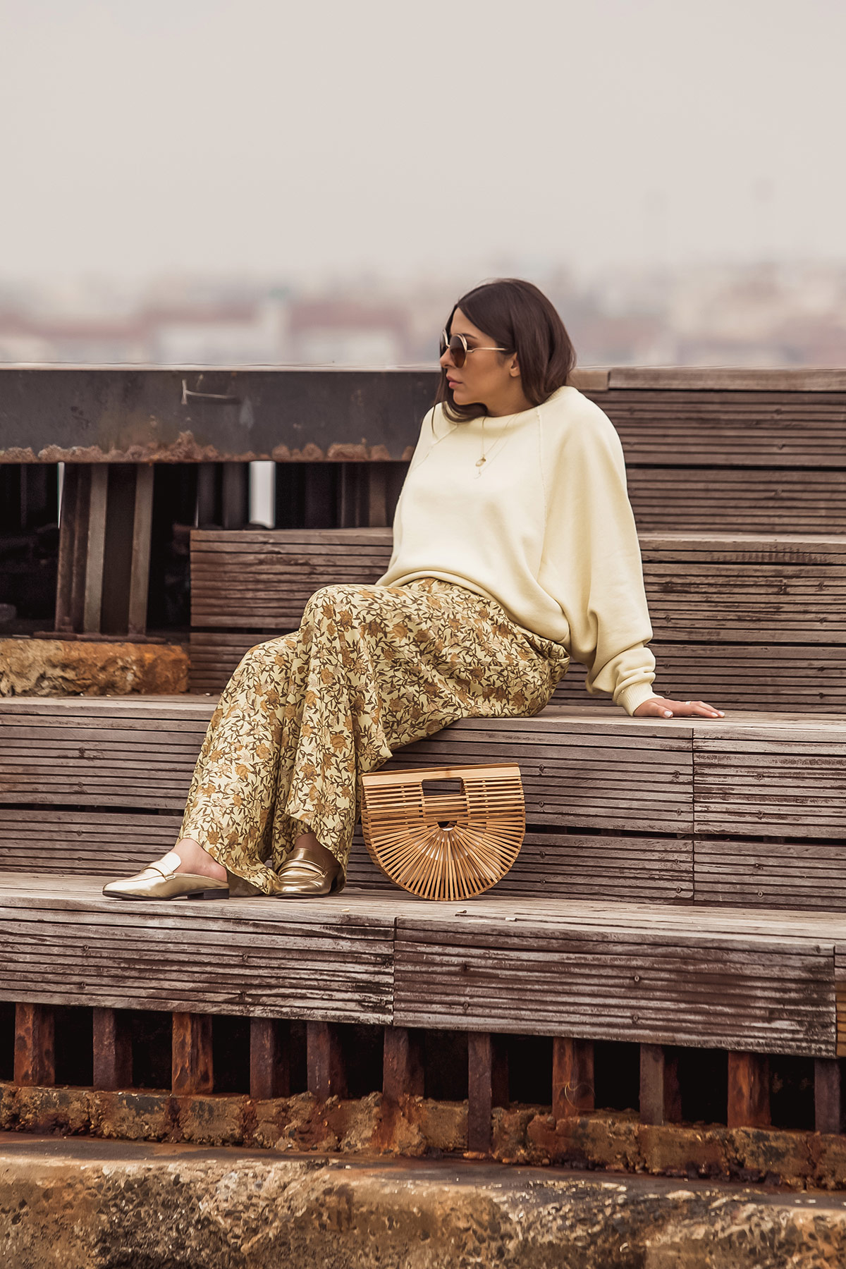 yellow trend Spring Summer 2018 - yellow outfit by Stella Asteria - Fashion & Style Blogger wearing yellow floral pants, yellow sweatshirt, Cult Gaia bag, and Chloé sunglasses