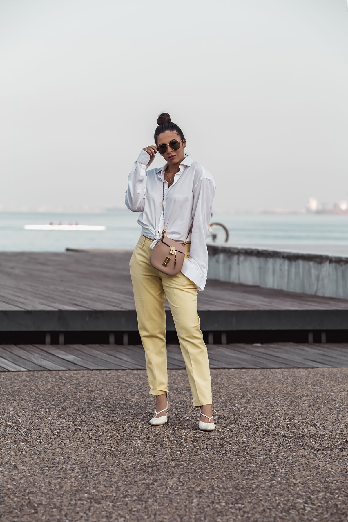 nursing outfit idea - Stella Asteria wearing men's shirt, yellow pants, Chloé Drew in cement pink and Gucci men's sunglasses