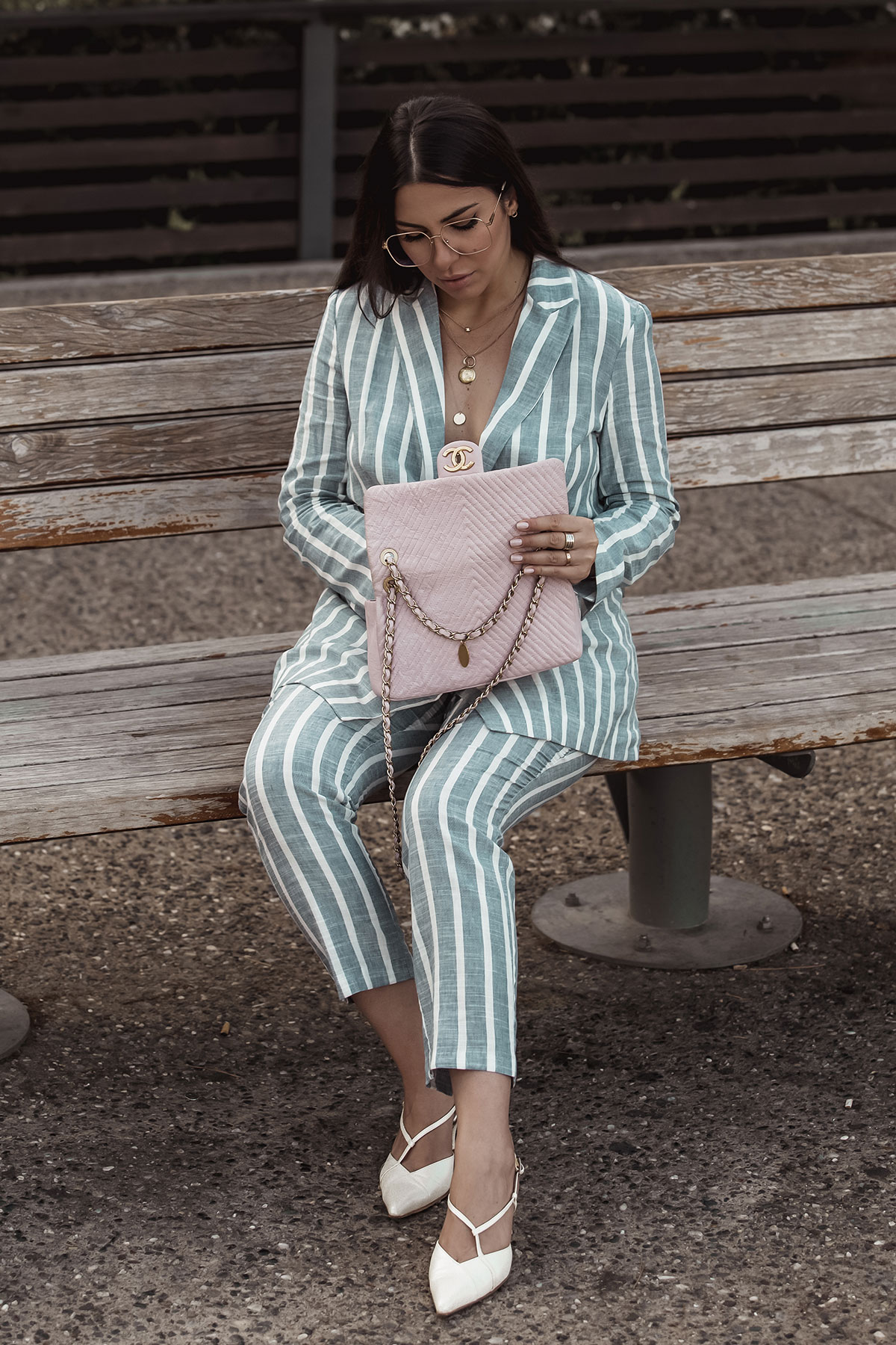 Stella Asteria wearing striped suit and pink Chanel chevron bag
